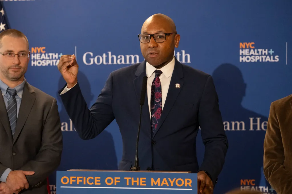 Queens Borough President Donovan Richards speaks at a podium.