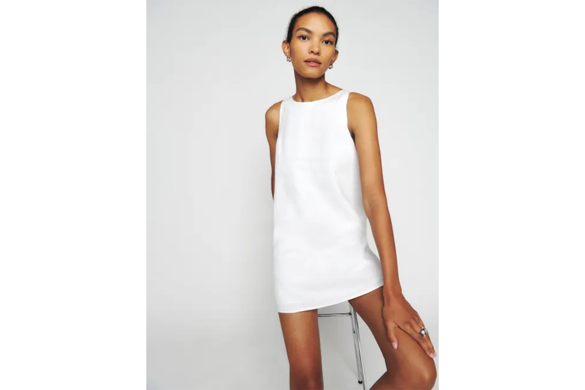 Model wearing a white mini dress.