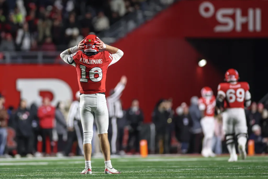 Rutgers quarterback Athan Kaliakmanis reacting to a play with his hands on his helmet.