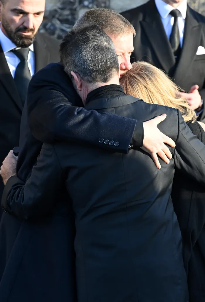 Simon Cowell embracing Liam Payne's parents at his funeral.