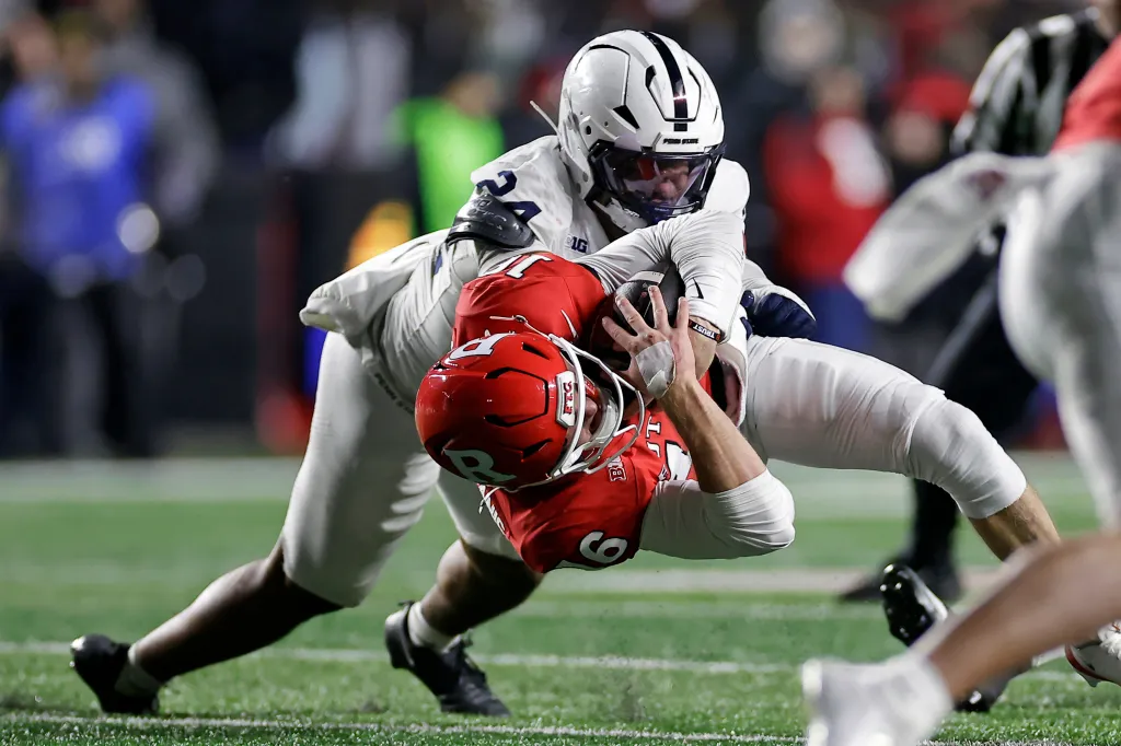 Rutgers quarterback Athan Kaliakmanis (16) is tackled by Penn State linebacker Amare Campbell (24).