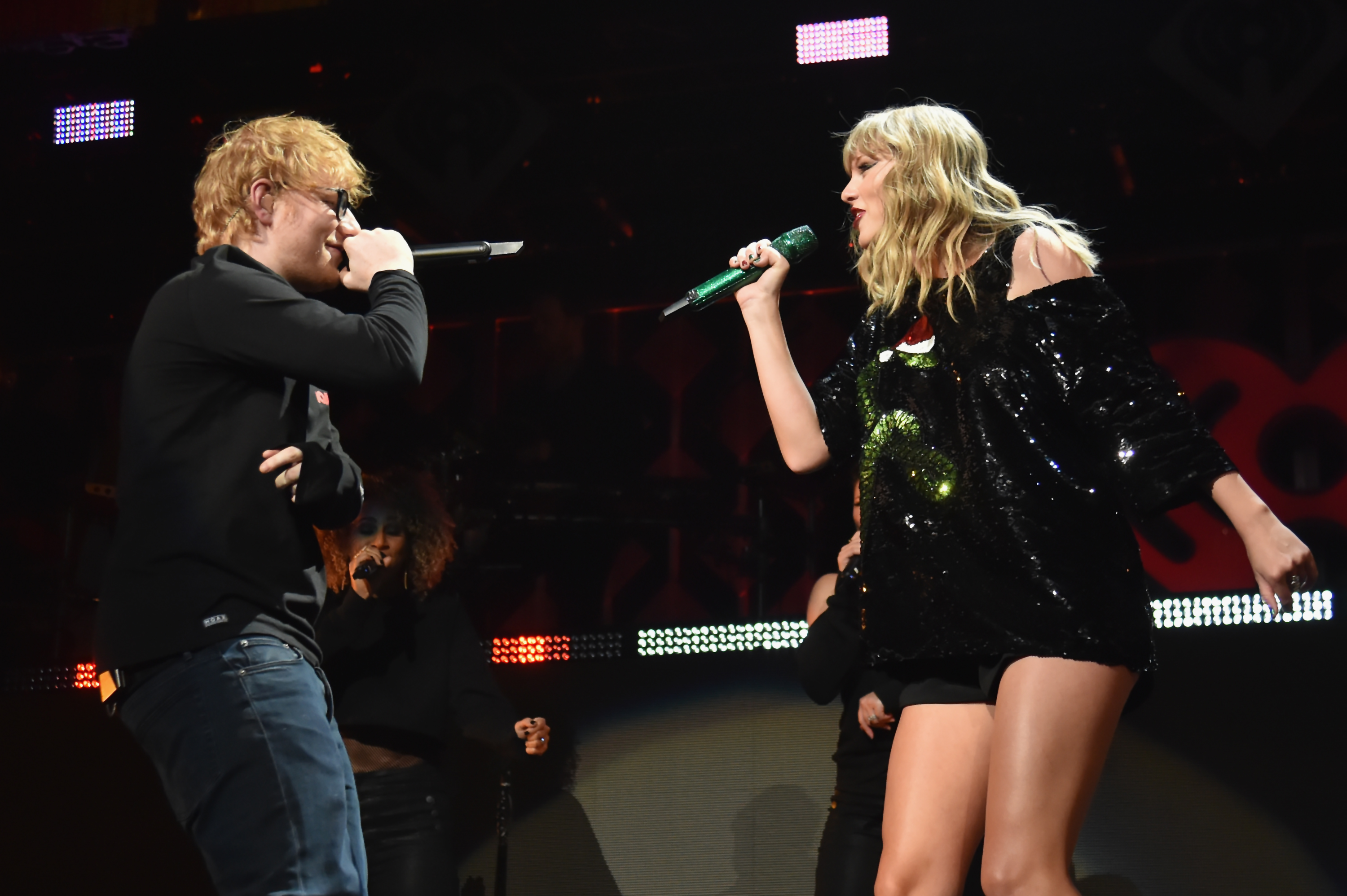 Taylor Swift and Ed Sheeran perform onstage.
