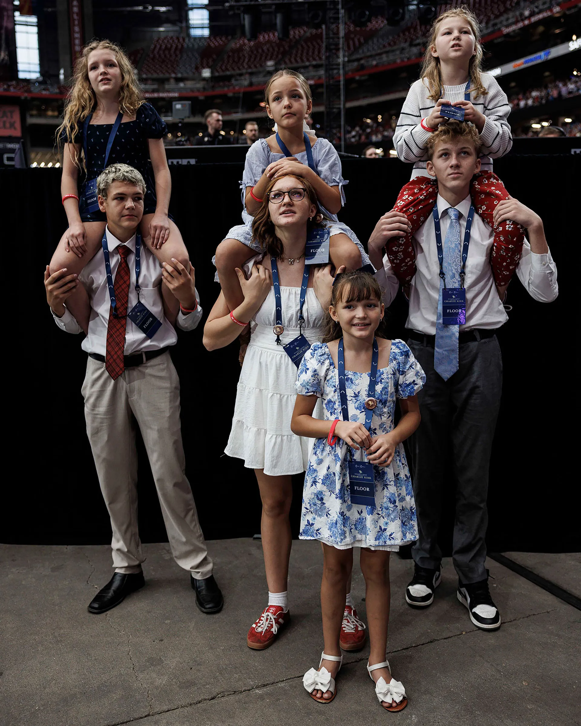 Attendees pray during a memorial service for Charlie Kirk at State Farm Stadium, in Glendale, Arizona, on September 21, 2025.