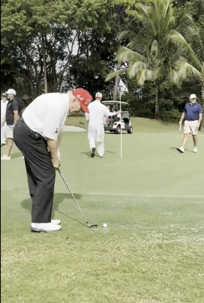 President Donald Trump lines up a shot during a round of golf during the Thanksgiving weekend.
