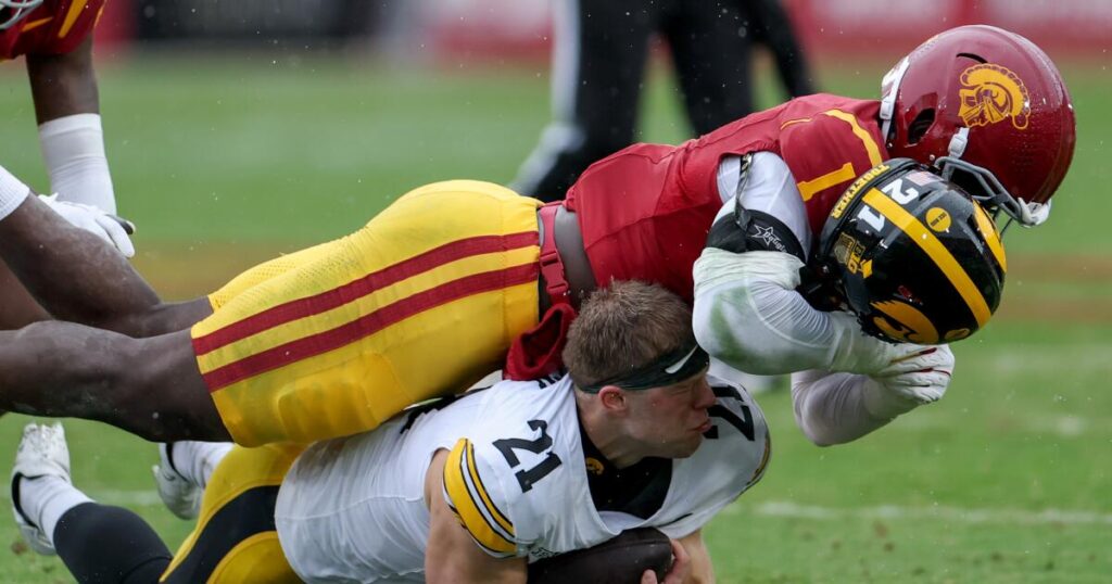 USC keeps its playoff hopes alive with downpour of toughness against Iowa