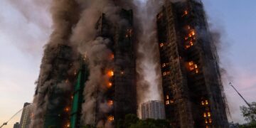 13 people killed in fire engulfing Hong Kong high-rise residential buildings, fire services say