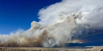 A wildfire and a rainbow: Dramatic photo shows California fire as storm rolls into region