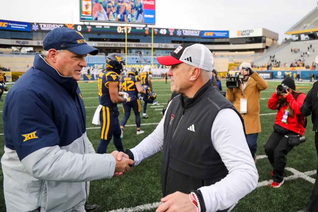 West Virginia Head Coach Rich Rodriguez shakes hands with Texas Tech Head Coach Joey McGuire after a game at Milan Puskar Stadium on Nov. 29, 2025.