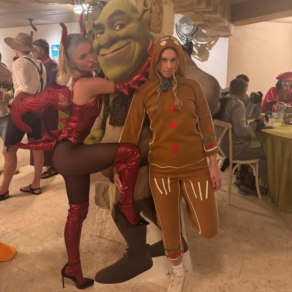 Sydney Sweeney dressed as a sexy dragon, posing with a woman in a gingerbread costume and a Shrek cutout at a Friendsgiving party.