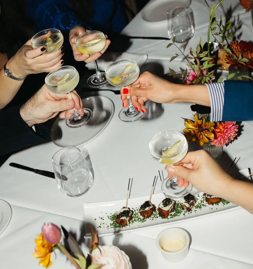 Guests cheersing at Charlie Palmer Steak IV restaurant 