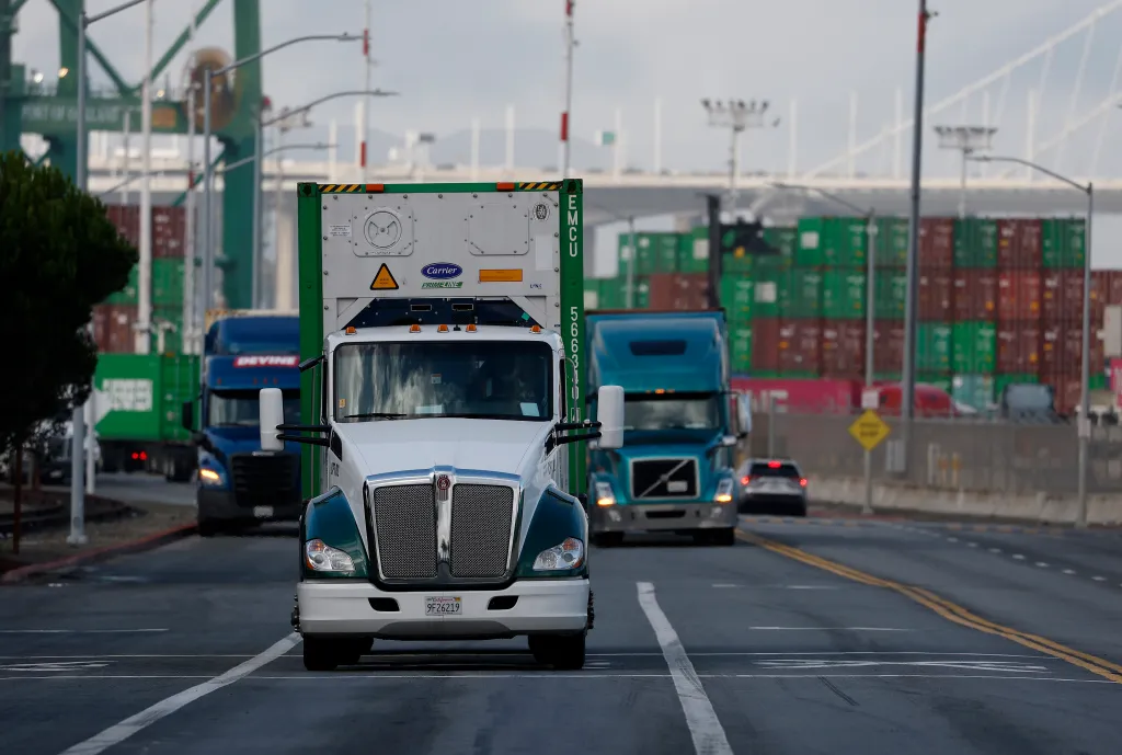 Commercial trucks driving in and out of the Port of Oakland, California.