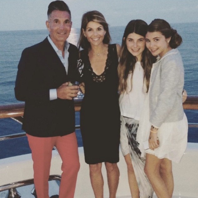 Lori Loughlin, Mossimo Giannulli, and their daughters, Isabella Rose and Olivia Jade, posing on a boat.