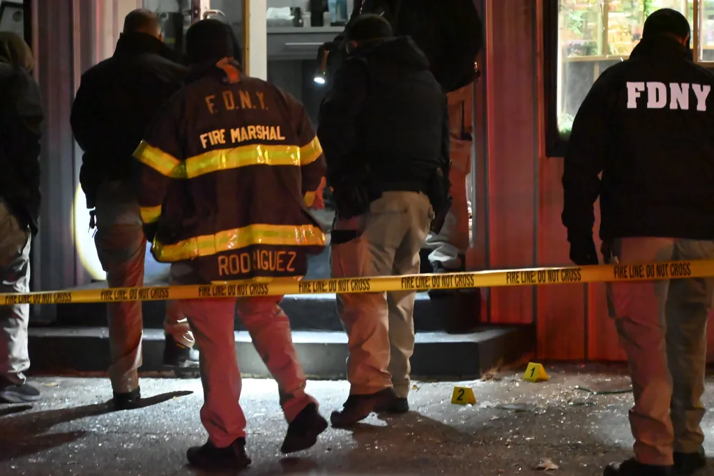 Fire Marshal and FDNY personnel behind a 