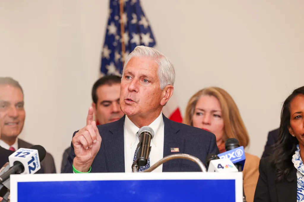 Nassau County Executive Bruce Blakeman speaks into microphones during an announcement.