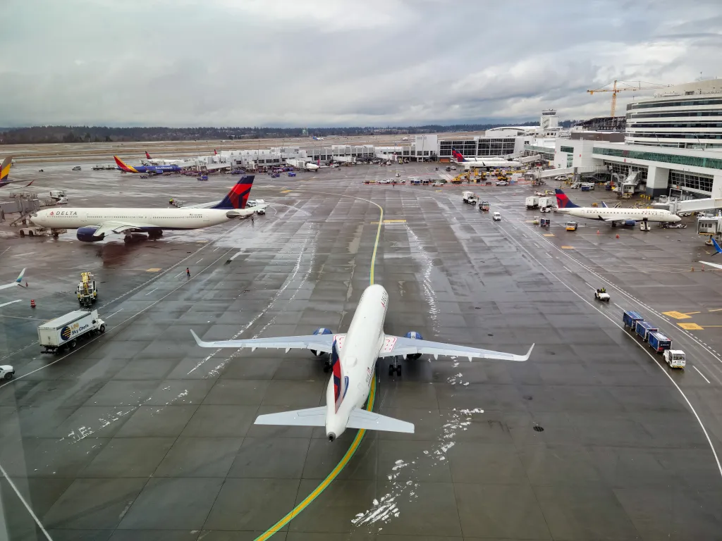 Aerial view of commercial aircraft at Seattle-Tacoma International Airport on a cloudy winter afternoon.
