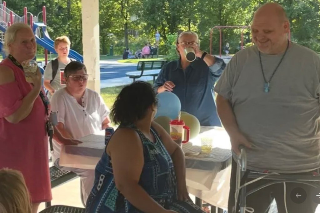 People gathered for a social event under a canopy.