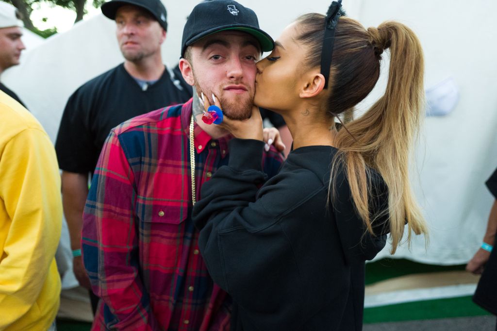 Ariana Grande kissing Mac Miller on the cheek.
