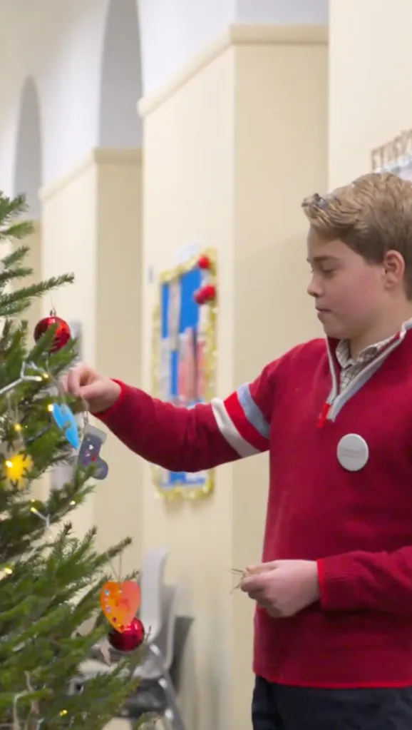 Prince George decorating a Christmas tree.