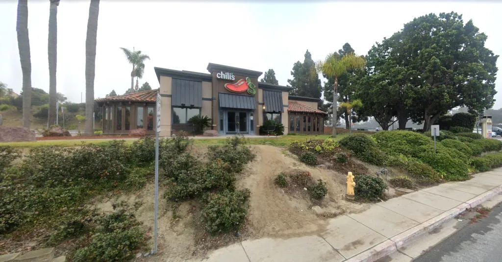 Chili's restaurant with surrounding trees and landscaping, seen from the street.