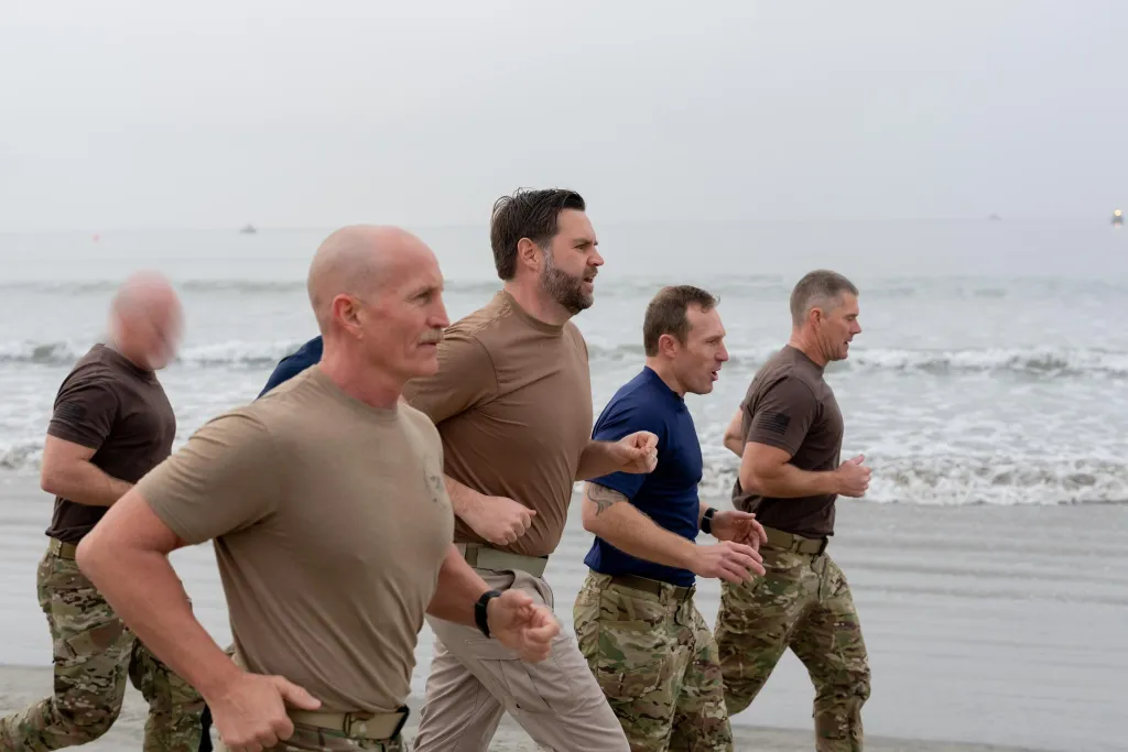 JD Vance training with Navy SEALs on a beach.