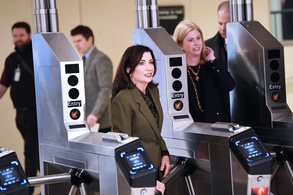 Governor Kathy Hochul at subway turnstiles.