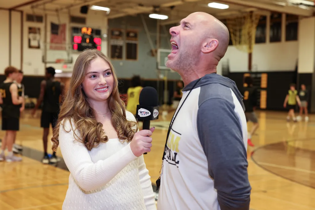 Alyssa Tappin interviewing a man with a microphone.