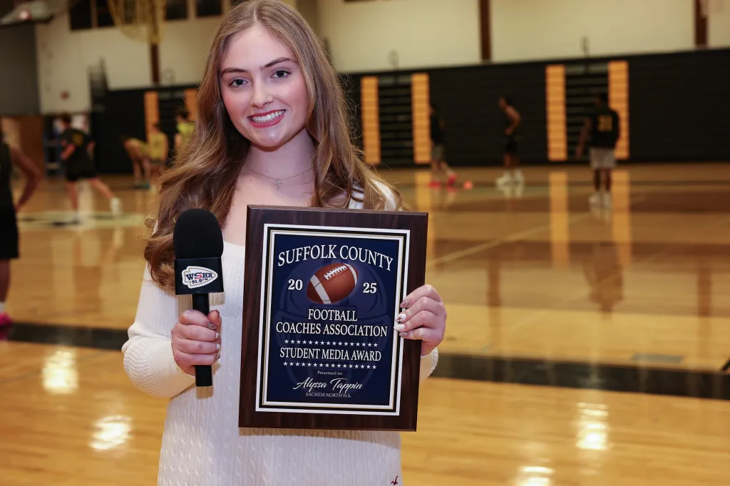 Alyssa Tappin holds a microphone and a