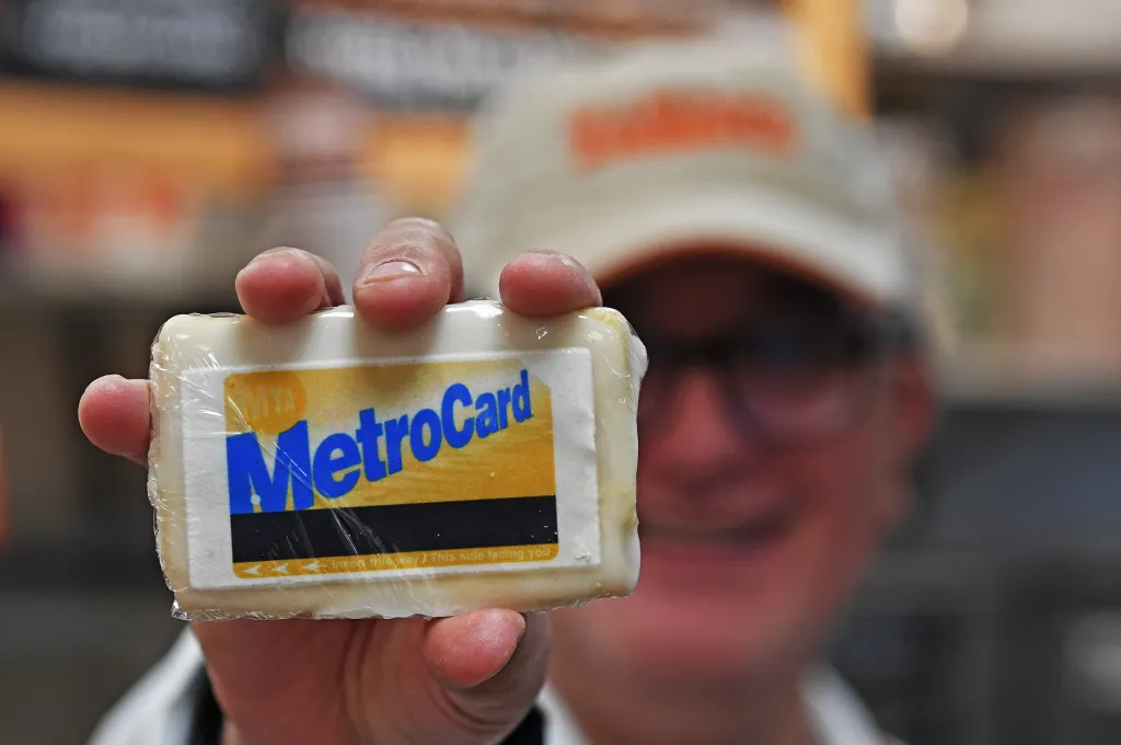 A worker holds up a Zabar's MetroCard cookie.