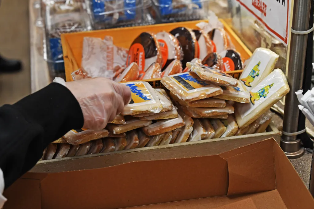 A man reaches for the MetroCard cookie.