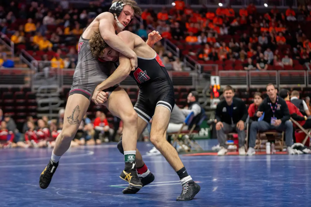 Assumption Davenport's Steele Diercks wrestles Oskaloosa's Kaiden Parker at 132 lbs during the Iowa high school boys state wrestling tournament on Thursday, Feb. 20, 2025, at Wells Fargo Arena in Des Moines