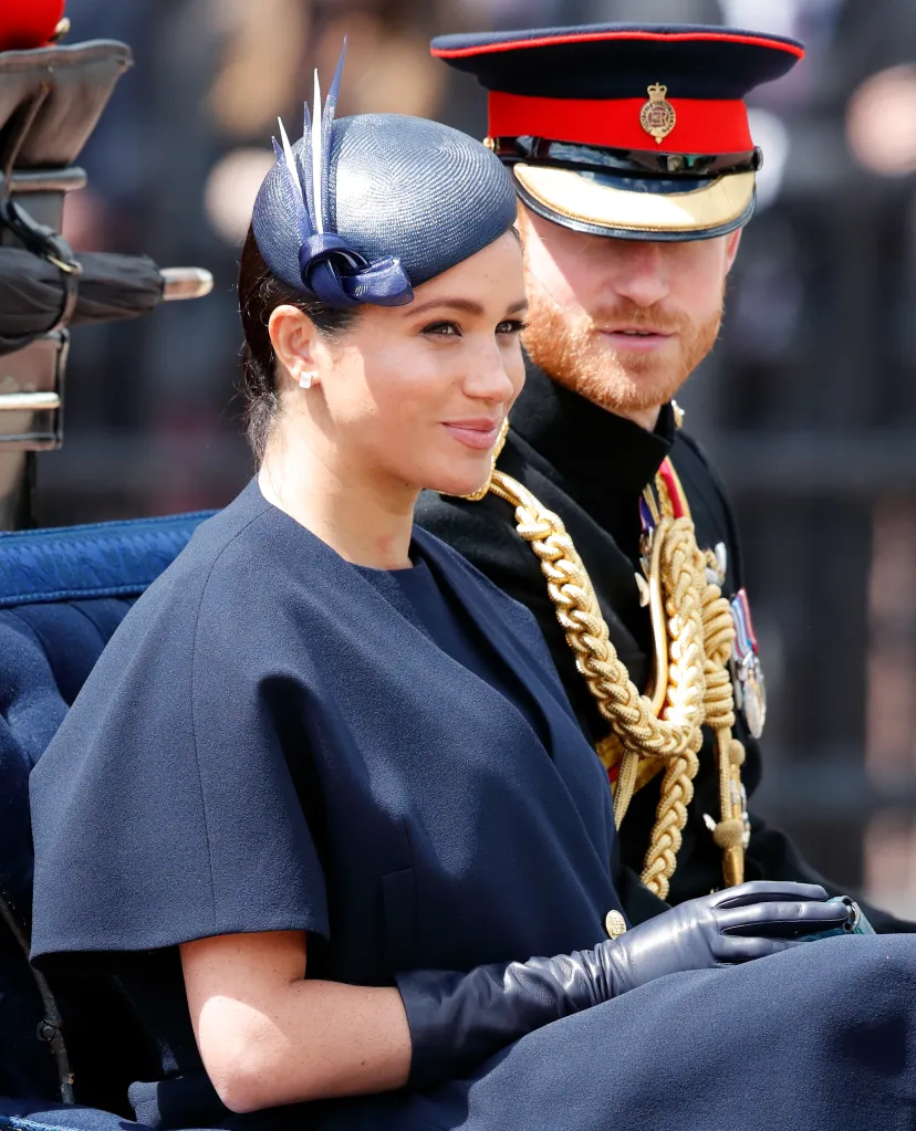 Meghan, Duchess of Sussex and Prince Harry, Duke of Sussex, travel in a horse-drawn carriage.