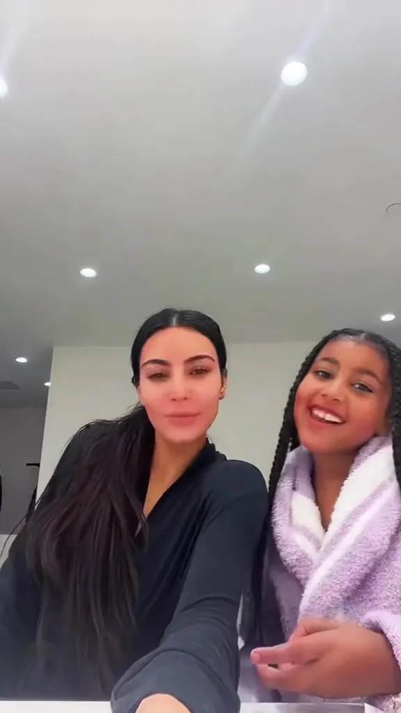 Kim Kardashian and North West smiling for a selfie.