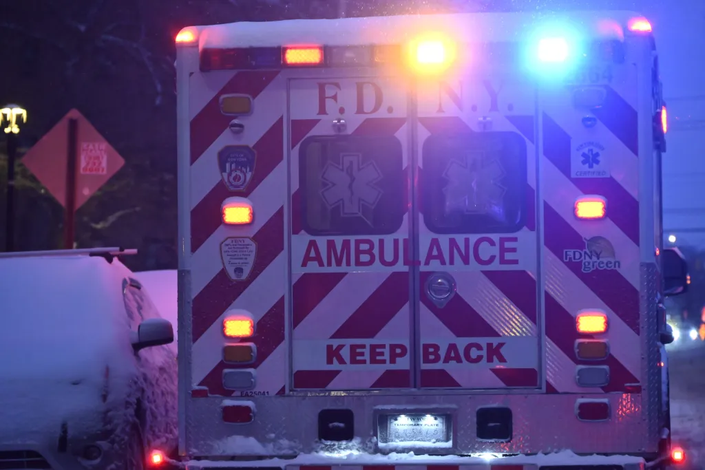 Rear of a FDNY ambulance with flashing lights at the scene of a 4-year-old girl's death investigation in Bronx, New York.