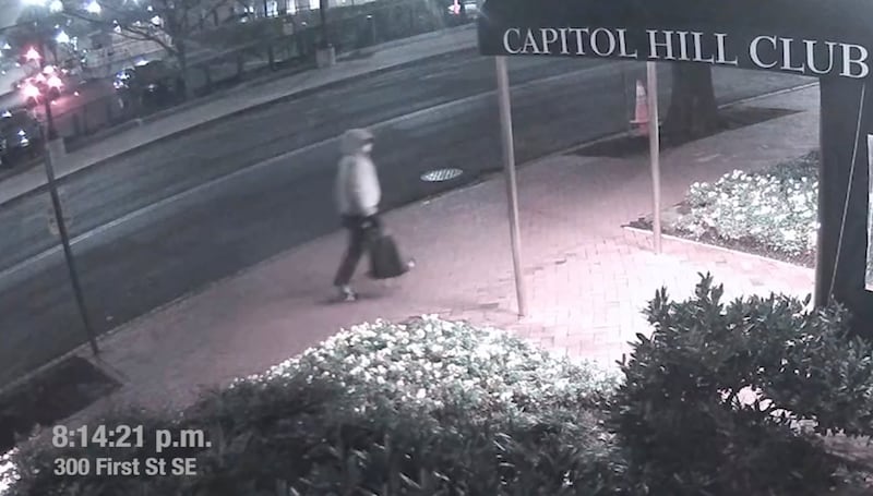 A suspect in the planting of explosive devices near the Democratic and Republican committee headquarters in Washington is seen walking past the Capitol Hill Club, also known as the National Republican Club of Capitol Hill, in Washington in this still frame taken from video released on March 9, 2021.