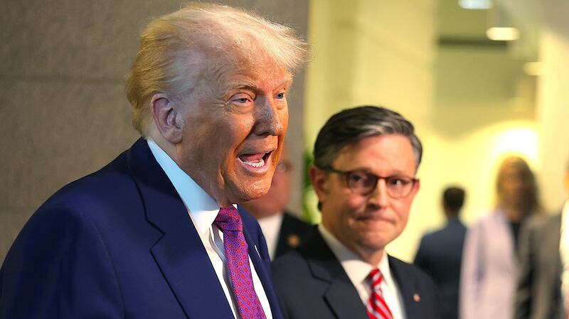 With Speaker of the House Mike Johnson (R-LA) by his side President Donald Trump speaks to the press.
