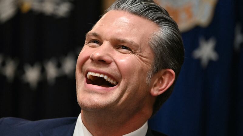 US Secretary of Defense Pete Hegseth laughs during a Cabinet Meeting hosted by President Donald Trump in the Cabinet Room of the White House in Washington, DC on December 2, 2025.