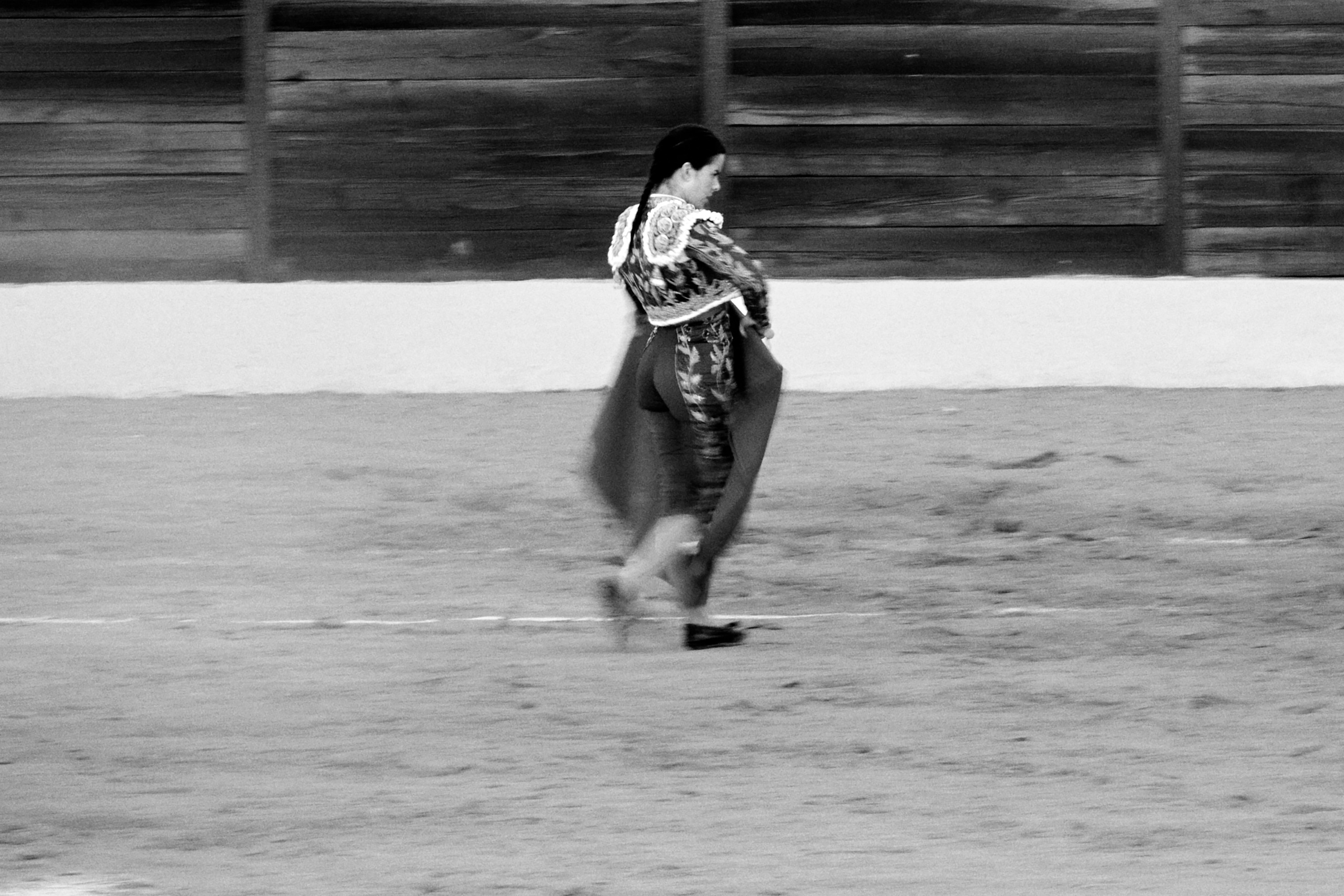 4 of 4 black-and-white photos of woman fighting large bull