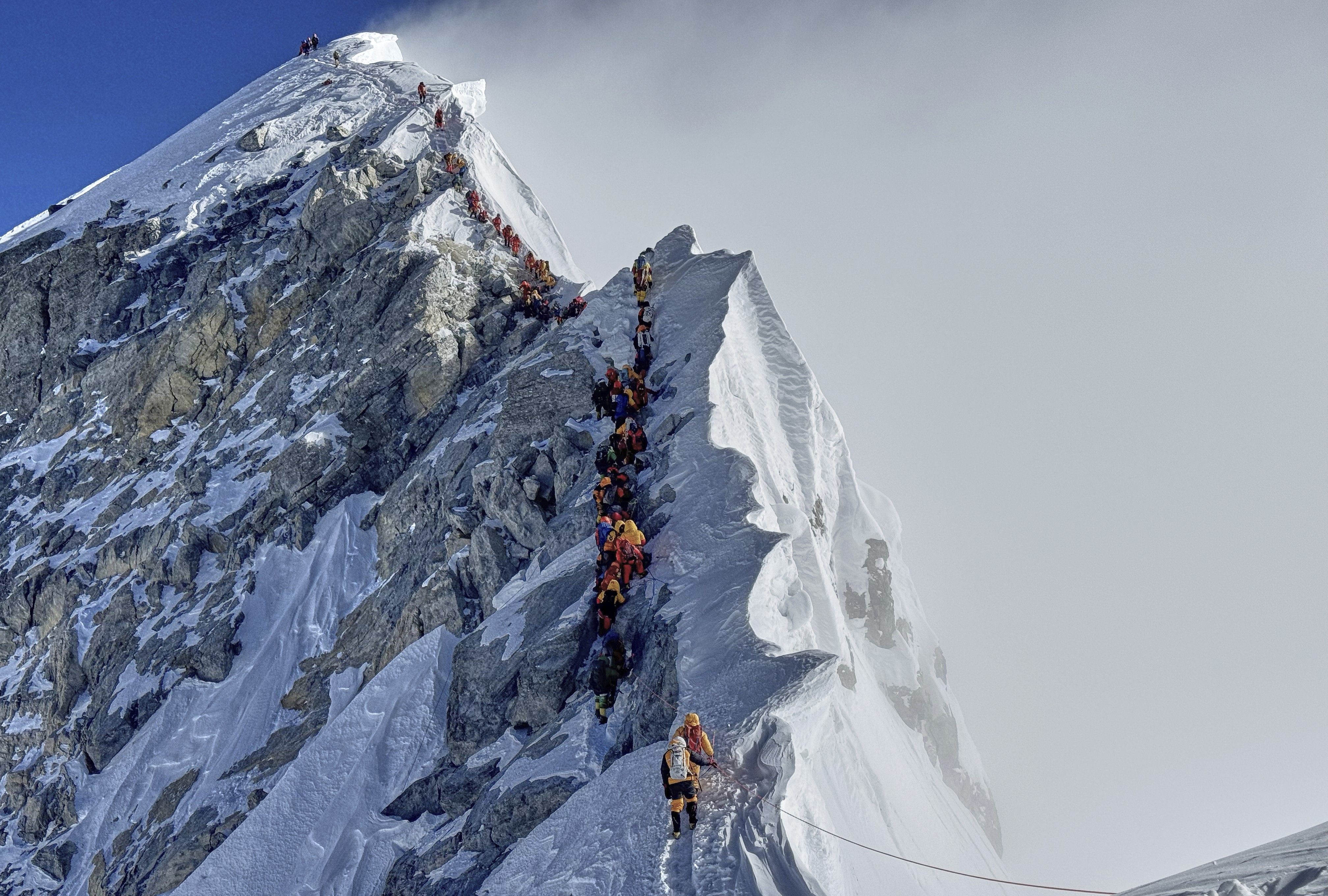 Mountaineers form a long queue as they approach the summit of Mount Everest.