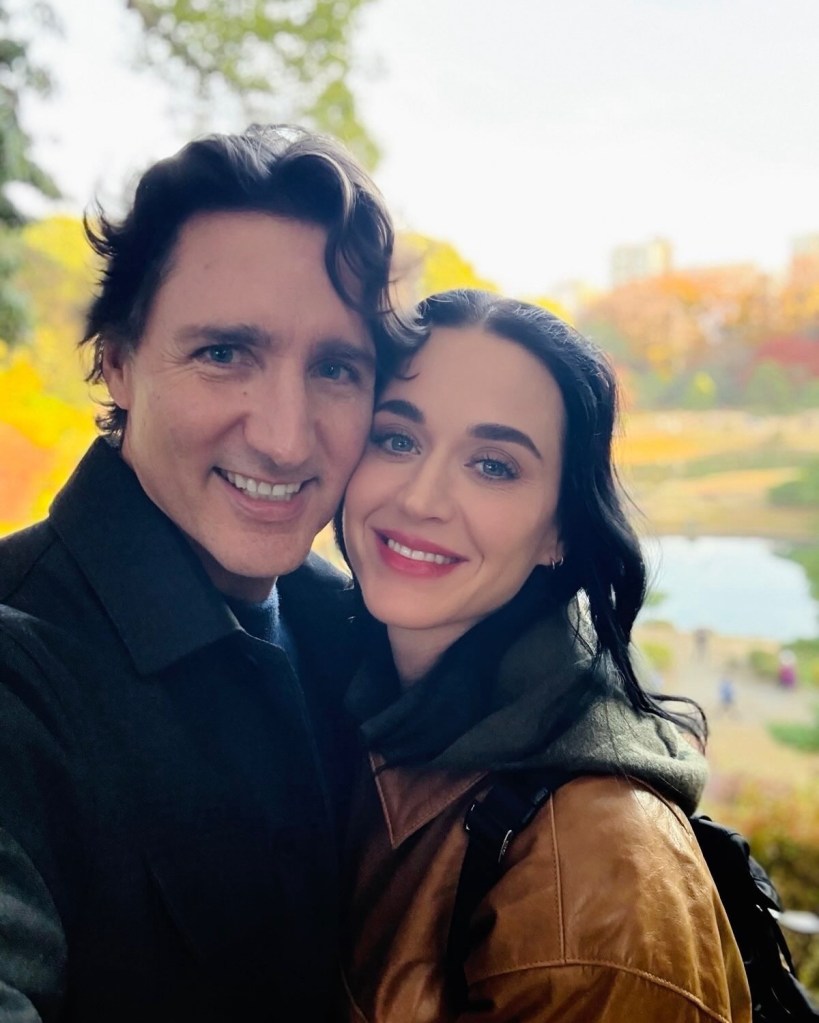 Katy Perry and Justin Trudeau smiling for a selfie.