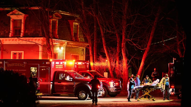 First responders with the Providence Fire Department maneuver an empty stretcher near the Barus & Holley building.