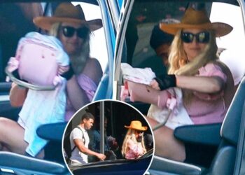 Britney Spears bizarrely totes toy baby carrier as she returns from Cabo with ripped fitness influencer