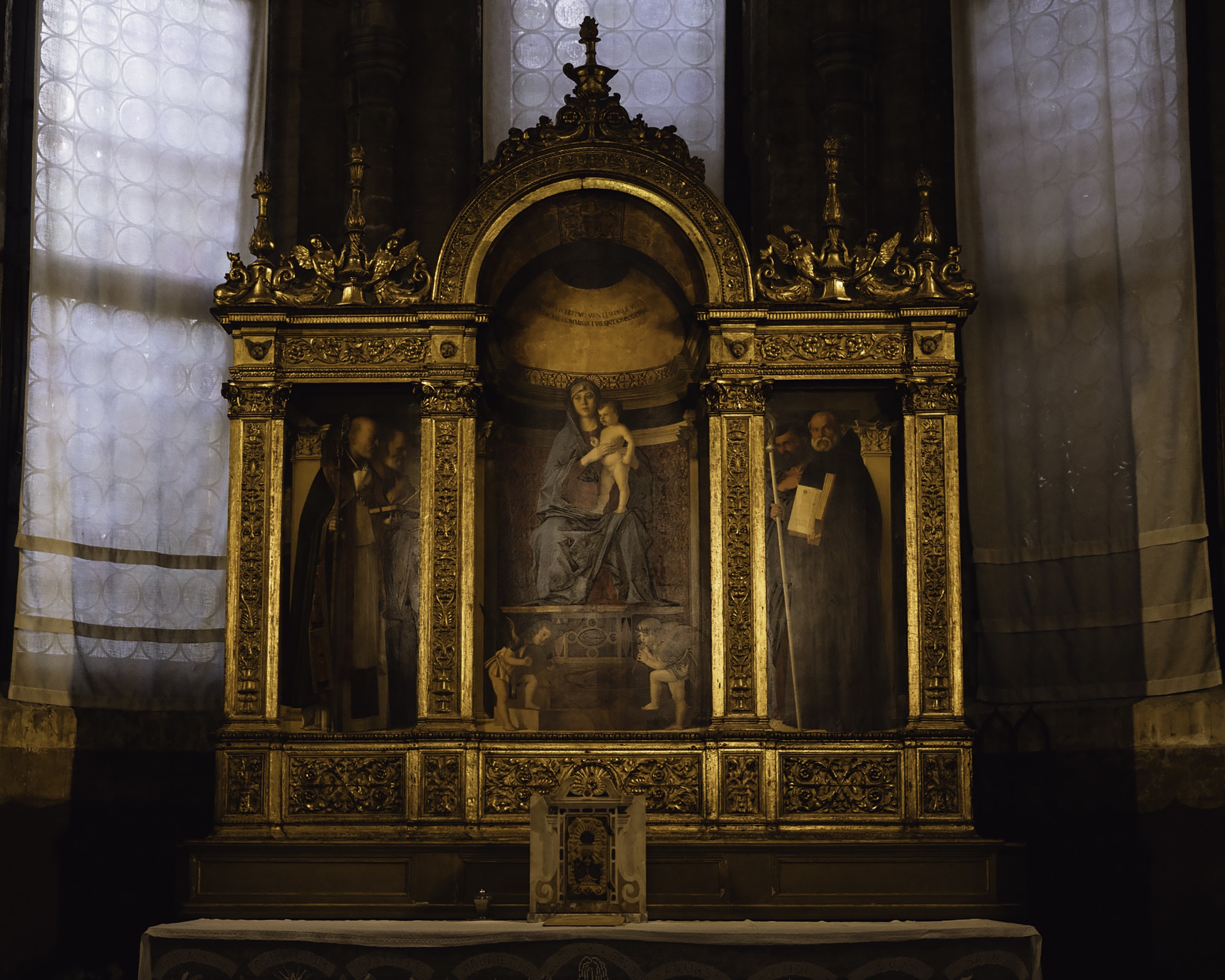  Inside of the Basilica di Santa Maria Gloriosa dei Frari with a statue of Mary and Jesus