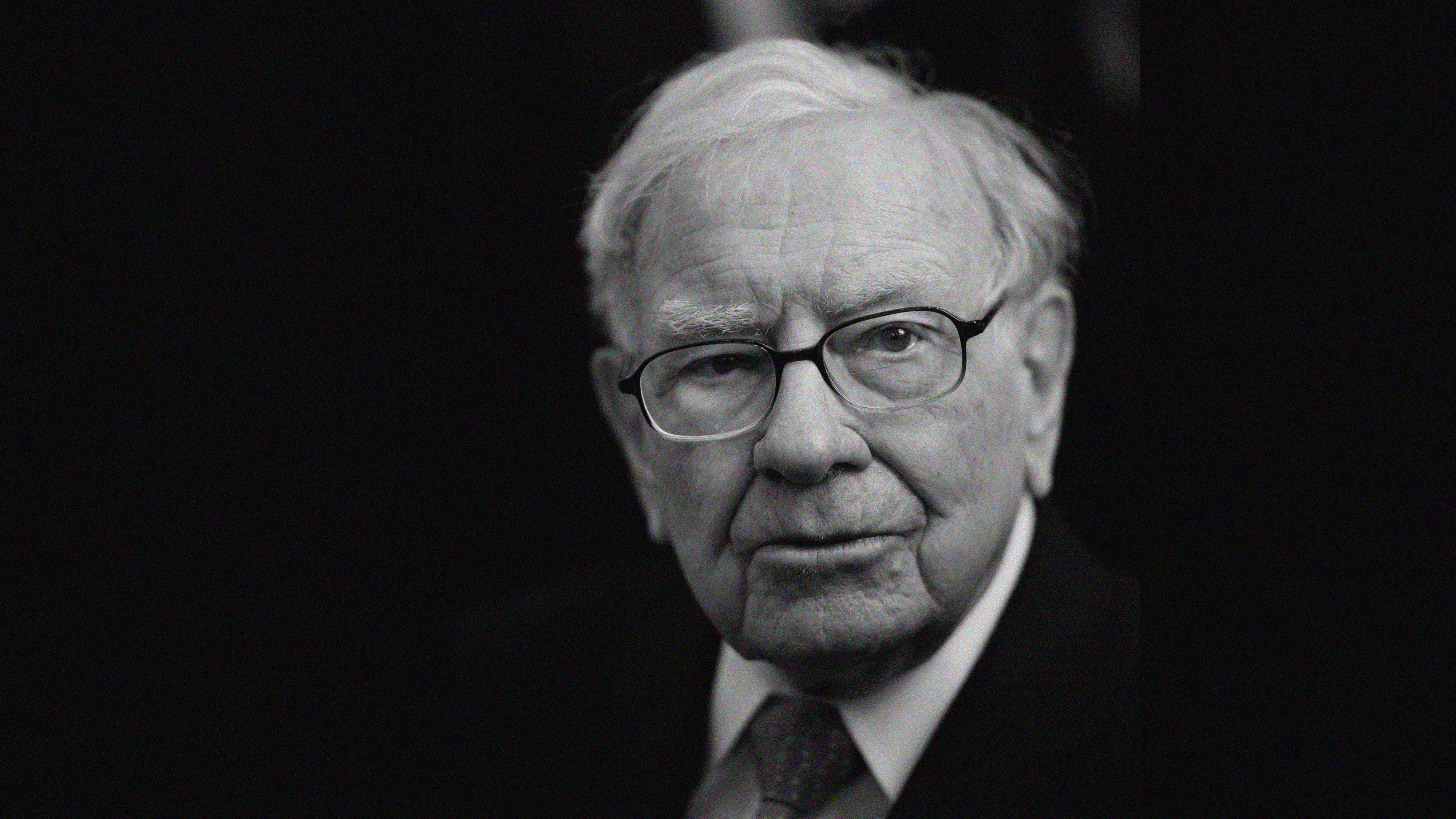 A black-and-white headshot of Warren Buffett