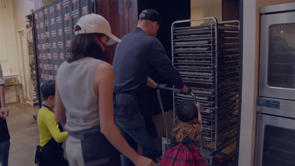 Prince Harry and Meghan Markle volunteer with their children.