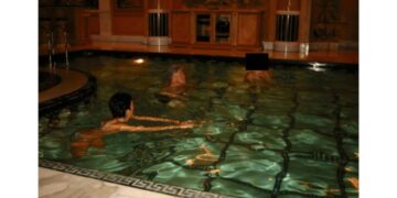 Among sea of redactions, photos of Bill Clinton emerge with Jeffrey Epstein, in a pool with Ghislaine Maxwell