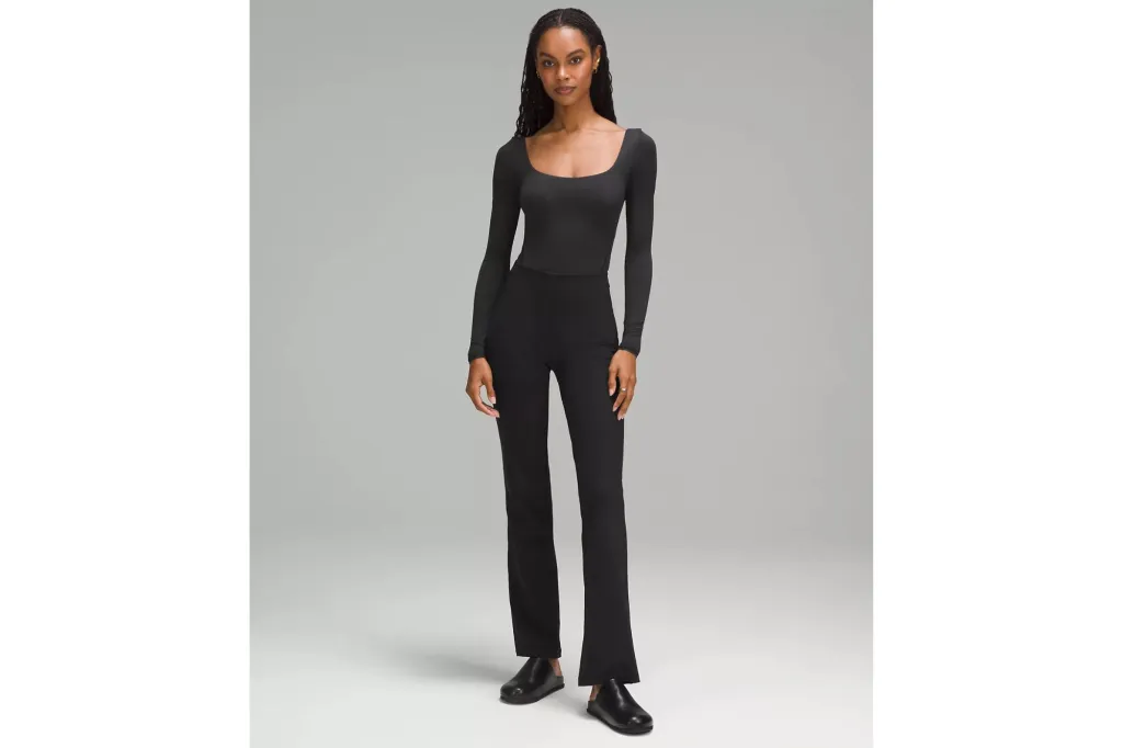 A woman wearing a bodysuit and pants.