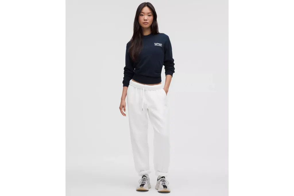 A woman in white sweats and a navy blue shirt.