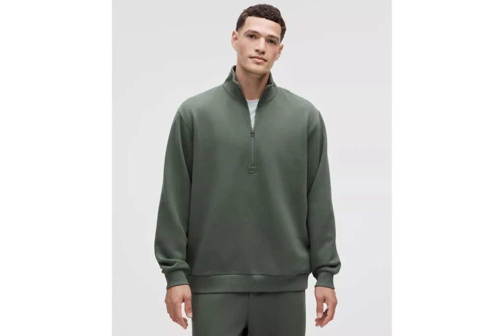 A man in a zip up sweatshirt.