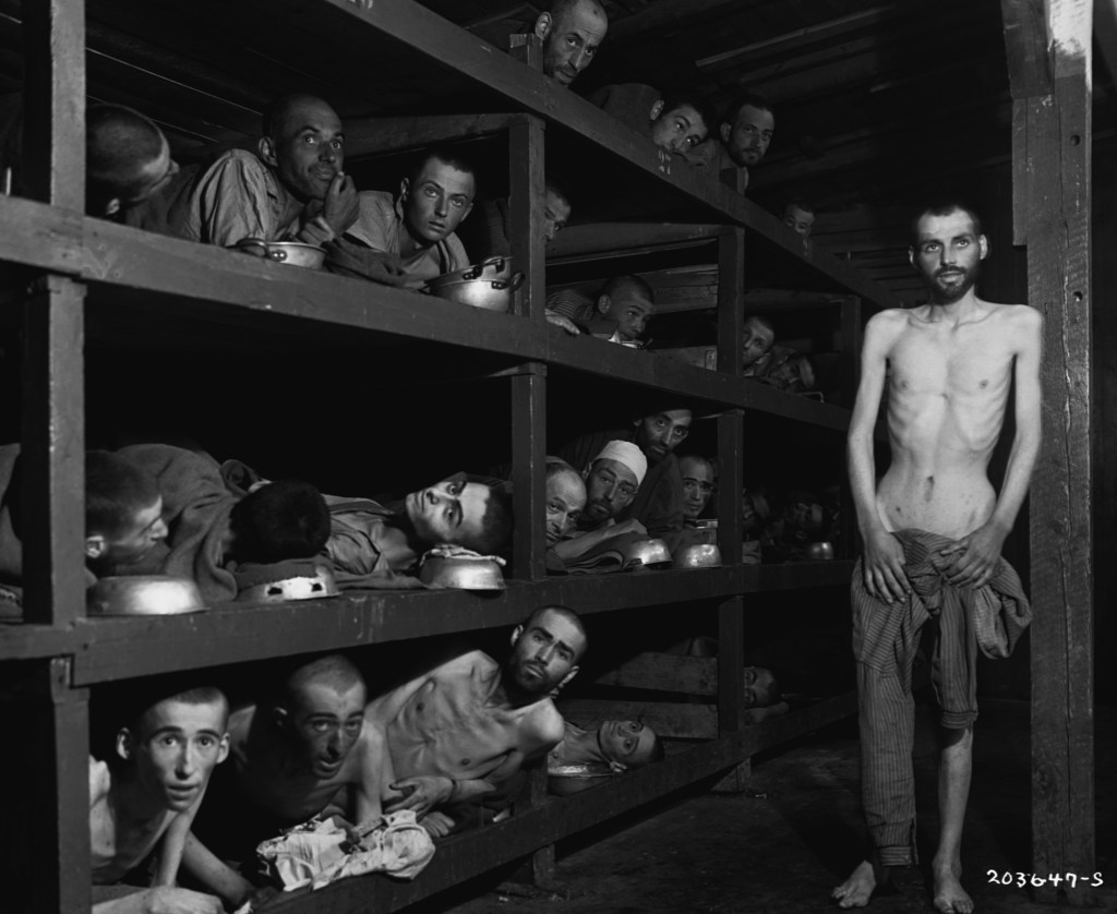 Survivors of Buchenwald Concentration Camp in their barracks. Elie Wiesel is on the second bunk from the bottom, seventh from the left.