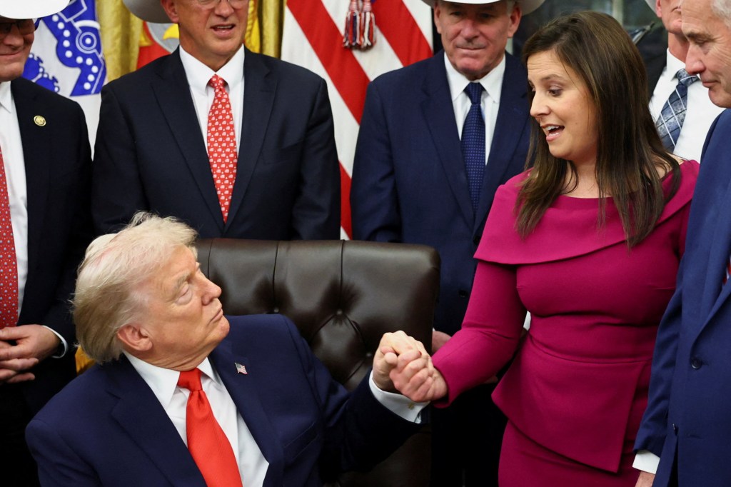 U.S. President Donald Trump holding hands with U.S. Rep. Elise Stefanik in the Oval Office.